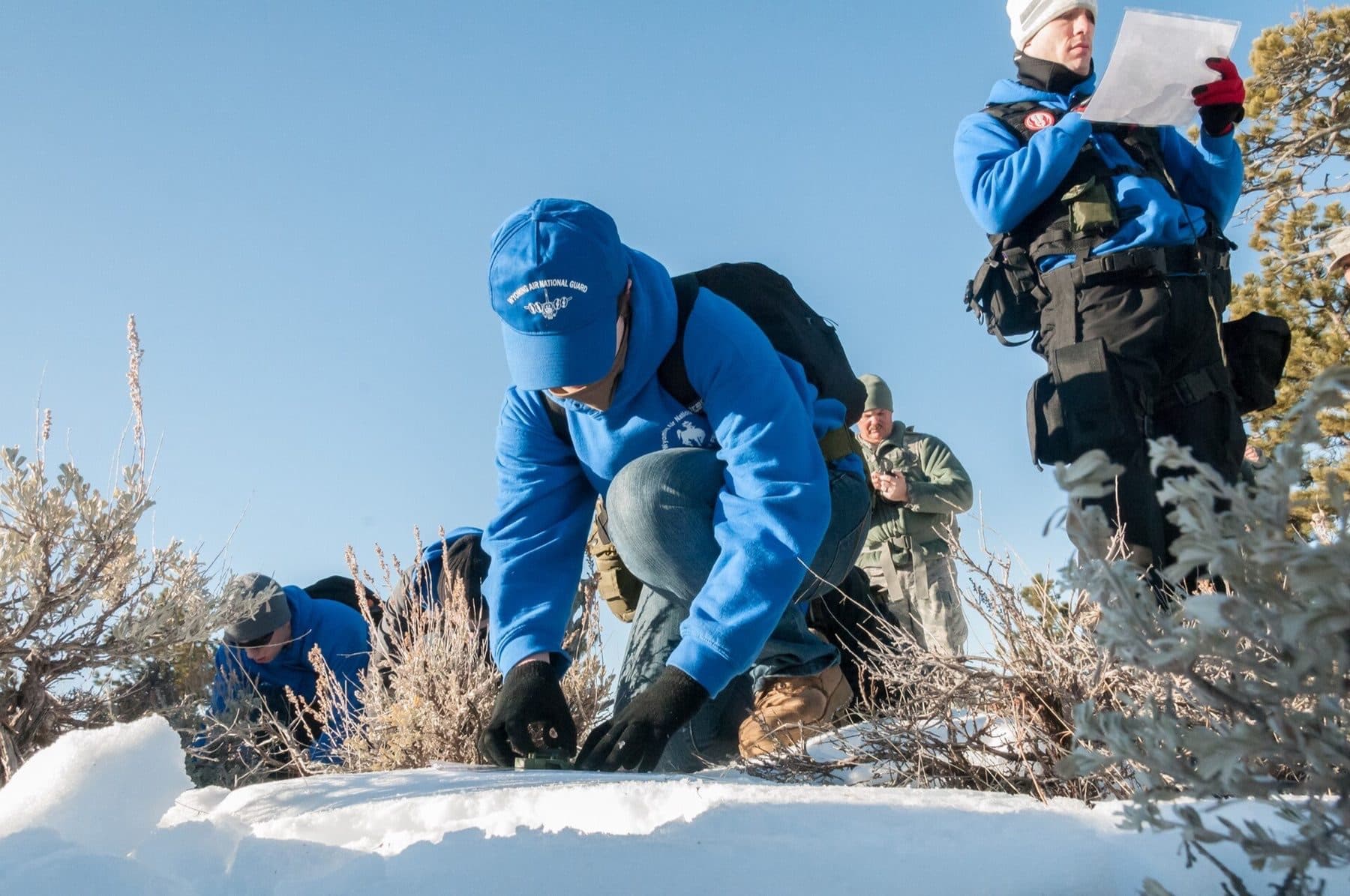 Caitlyn Levy assigned to the student flight, 153rd Airlift Wing, Wyoming Air National Guard orients a compass March 8, 2015, near Curt Gowdy State Park in Laramie County, Wyoming