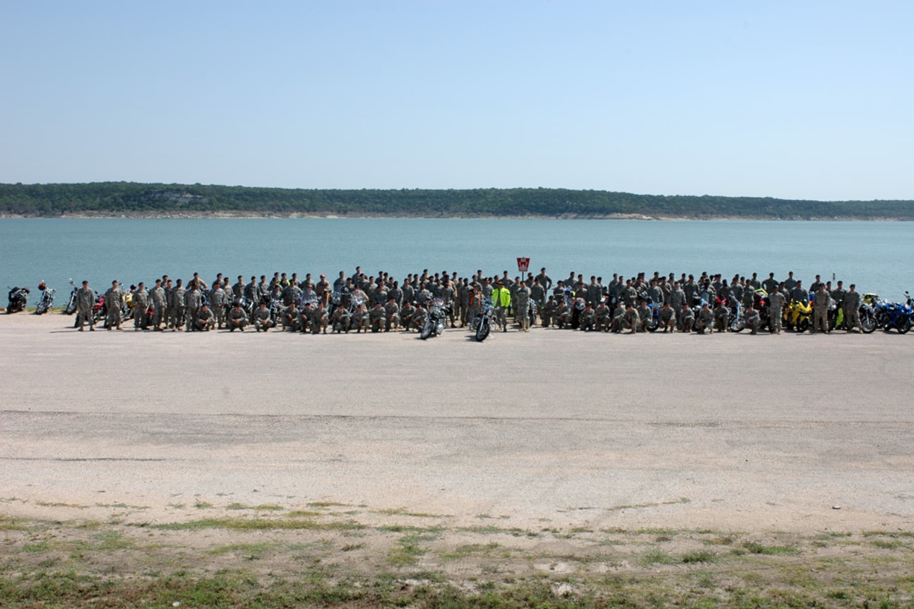 Soldiers from the 1st Air Cavalry "Warrior" Brigade, 1st Cavalry Division, gather together for a photo at Belton Lake Outdoor Recreation Area, Texas, after their motorcycle safety 