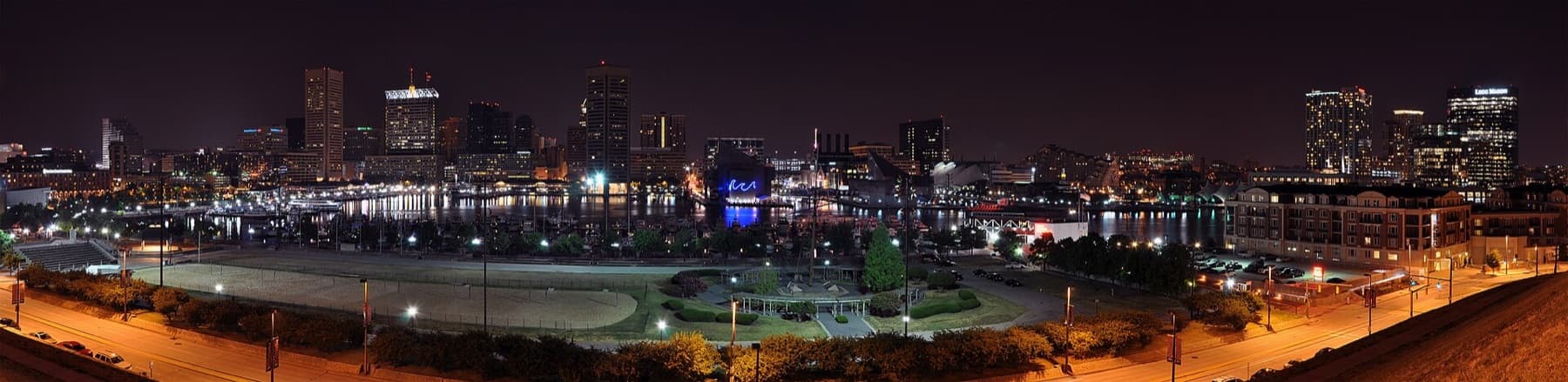 A four segment panorama of Baltimore's Inner Harbor skyline taken at night from Federal Hill