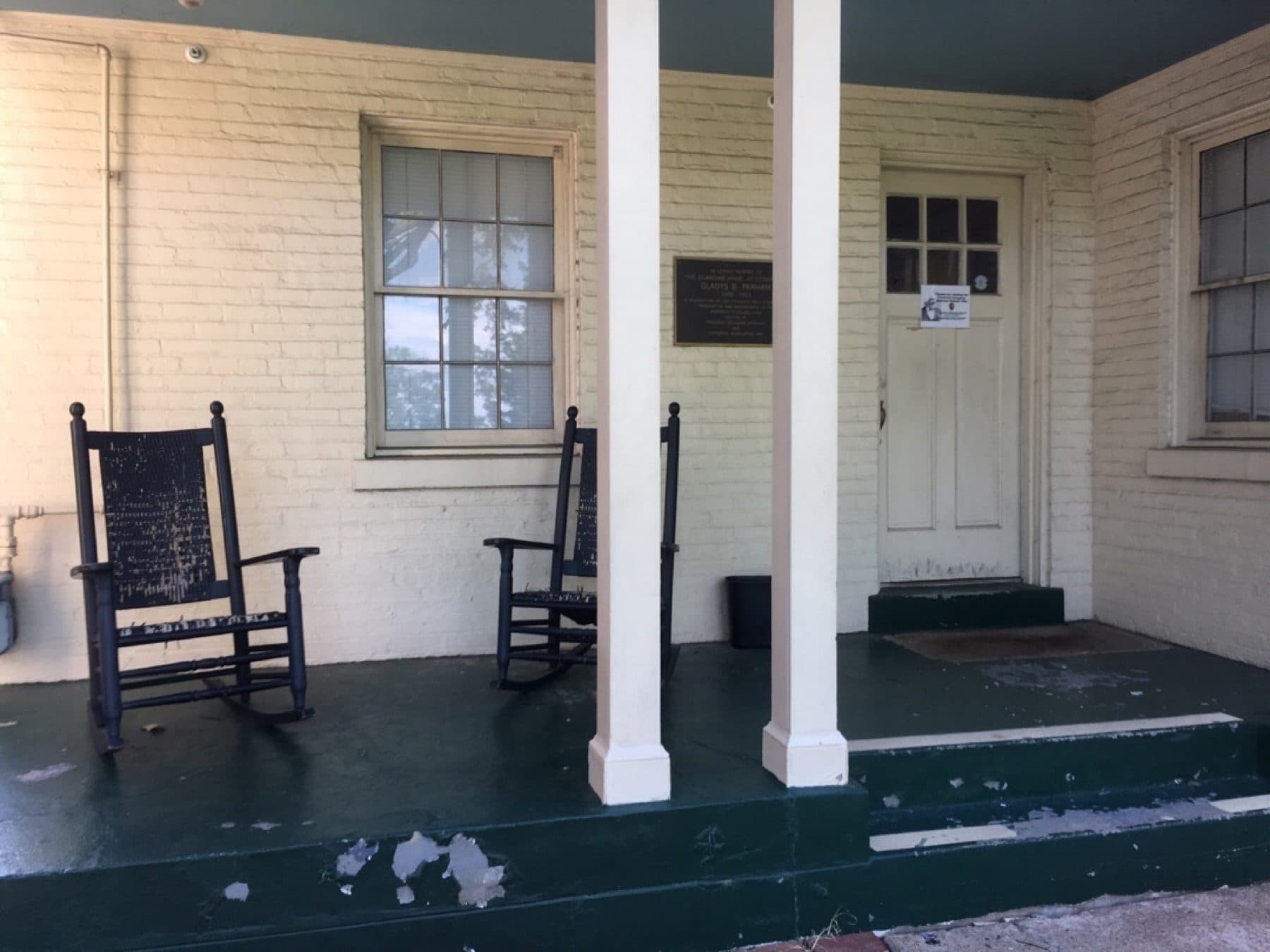 A porch with two rocking chairs