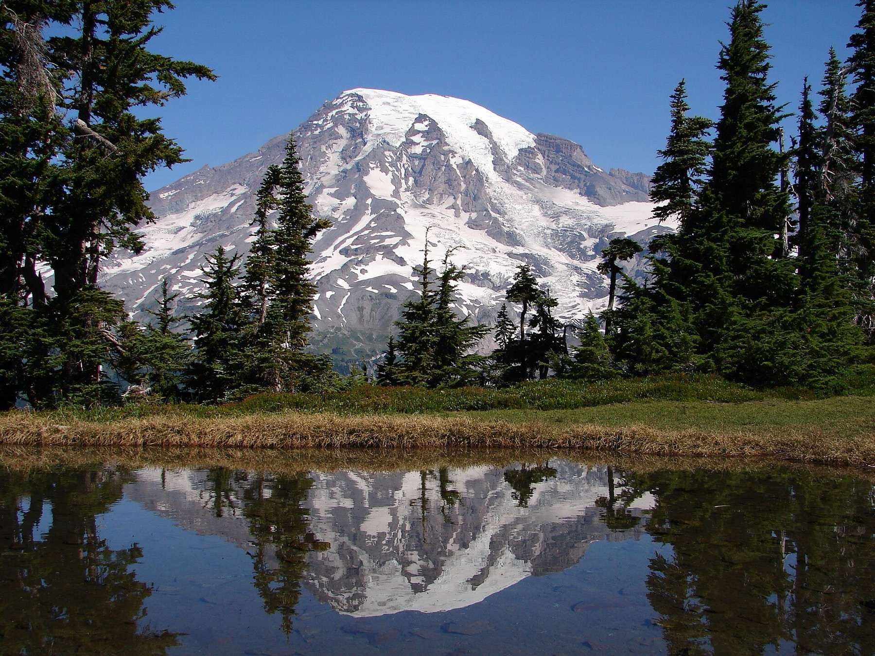 "Mount Rainier reflects in a small lake at the top of the Tatoosh Range." Mount Rainier National Park in the U.S