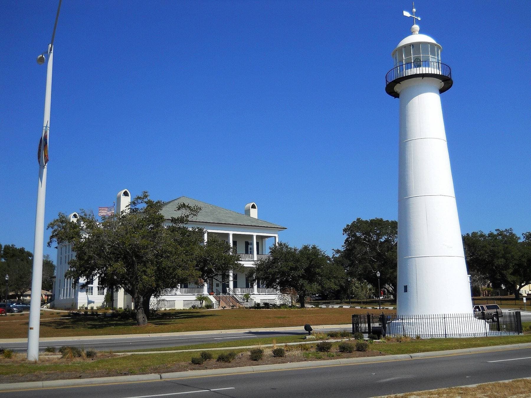 The Biloxi Lighthouse on U.S. 90 with the visitors center behind it