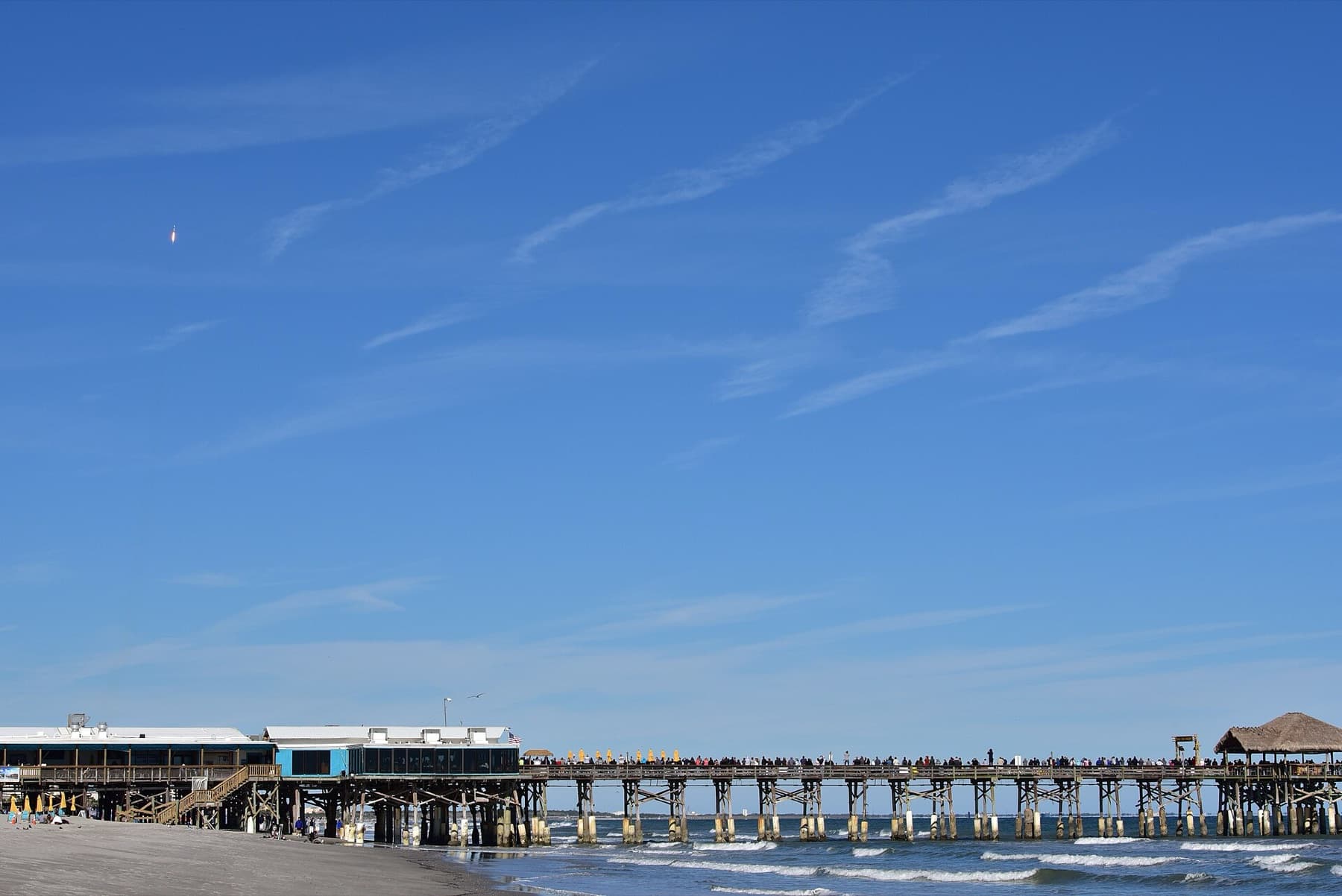 People watch SpaceX's Falcon 9 rocket CRS-16 liftsoff from Cape Canaveral Air Force Station, Space Launch Complex 40 on Dec 5, 2018 at Cocoa Beach, Fla