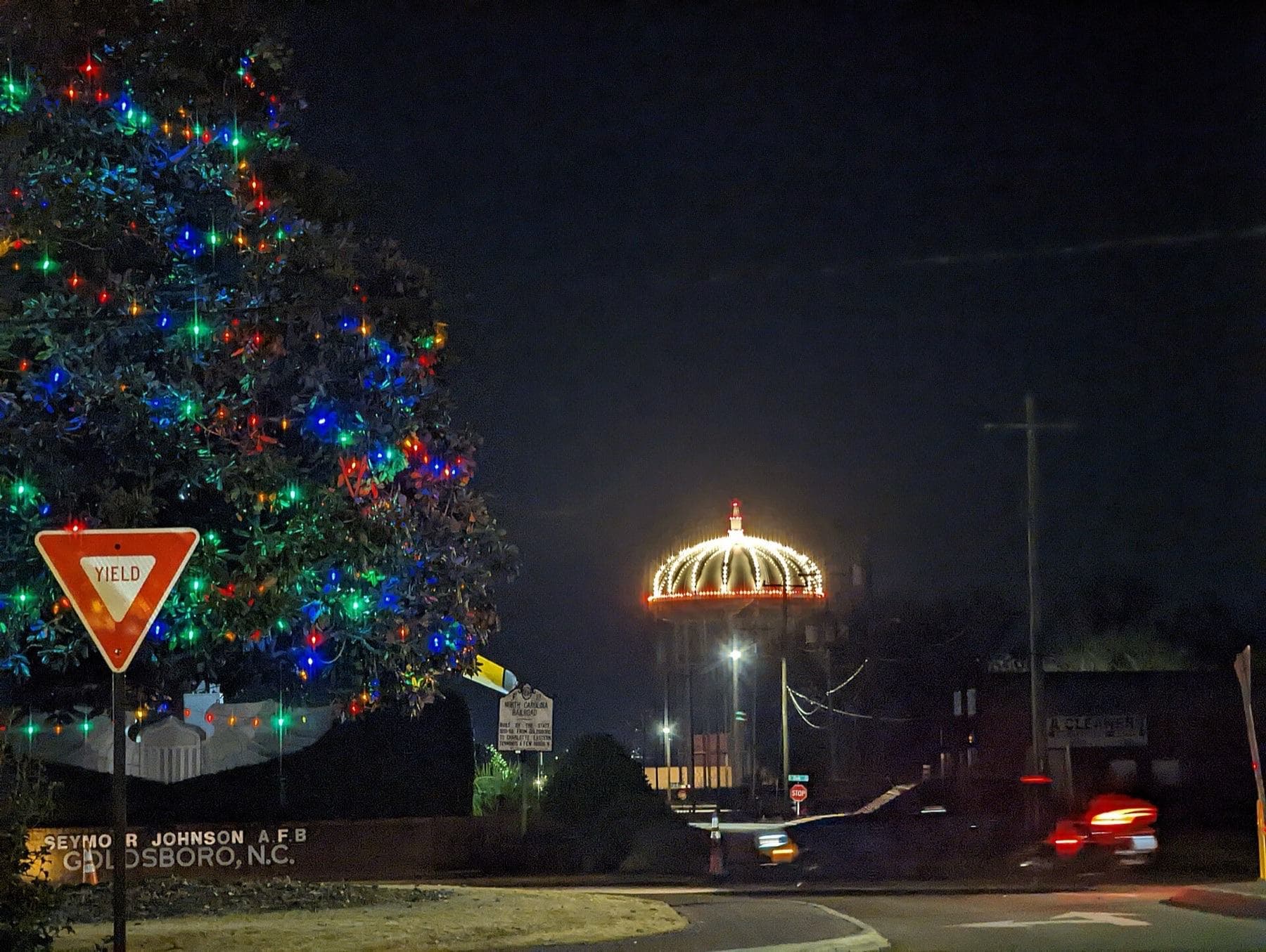 Image of the city Christmas tree and water tower decorated as a crown with white and red lights in downtown Goldsboro, North Carolina