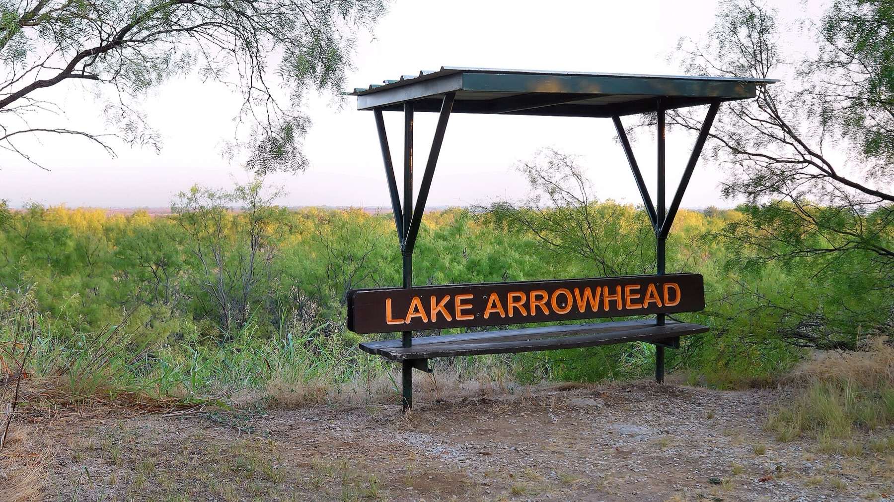 A park bench on the Mesquite Ridge Trail to rest and take in a view in Lake Arrowhead State Park in Wichita County, Texas, United States